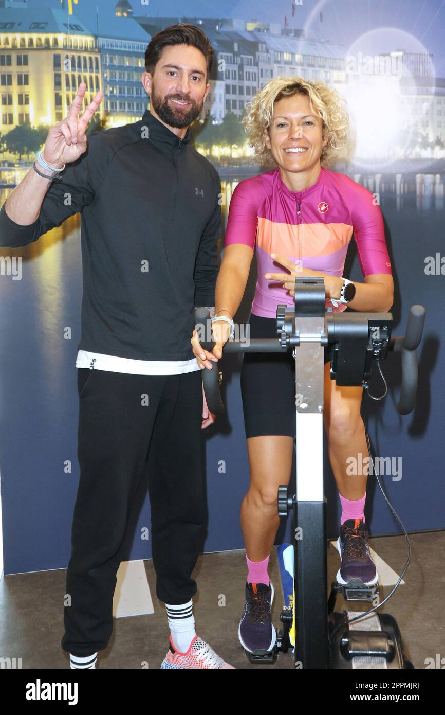 Sebastian Fobe,Annika Zimmermann,Charity cycling in the Europa Passage where a light bulb is illuminated with ergometers. The money goes 1:1 to Ukrainian aid projects in cooperation with the organization #WeAreAllUkrainians,Hamburg Stock Photo