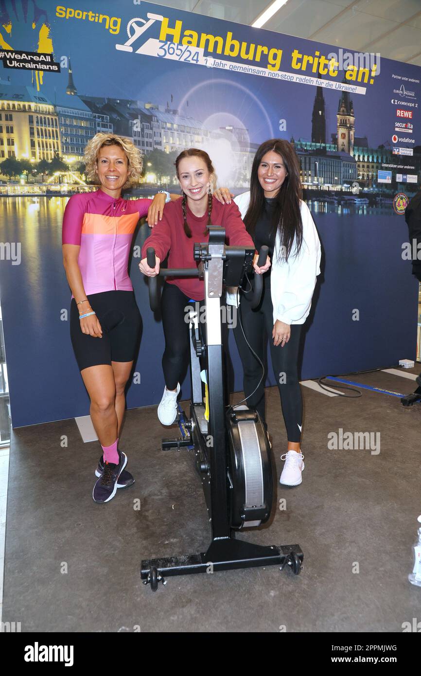 Annika Zimmermann,Svenja TheiÃŸen,Alicia Alvarez,charity cycling in the Europa Passage where a light bulb is illuminated with ergometers. The money goes 1:1 to Ukrainian aid projects in cooperation with the organization #WeAreAllUkra Stock Photo