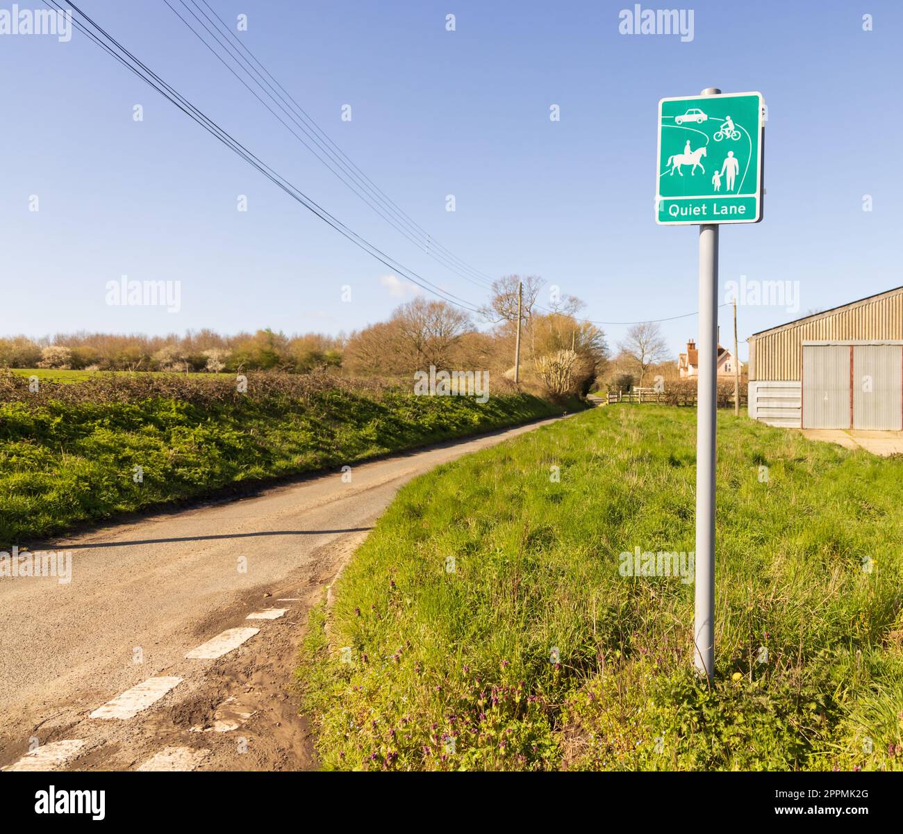A Quiet Lane sign on single-track road where visitors and locals can enjoy the natural surroundings where less than 1000 cars a day use that road. Stock Photo