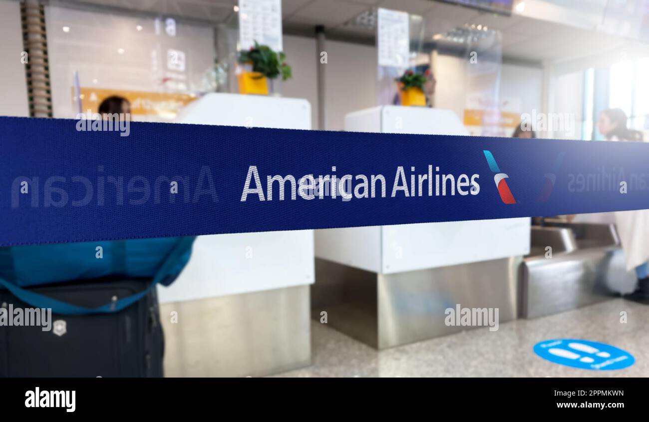 Blue barrier tape with the American Airlines logo inside an airport Stock Photo