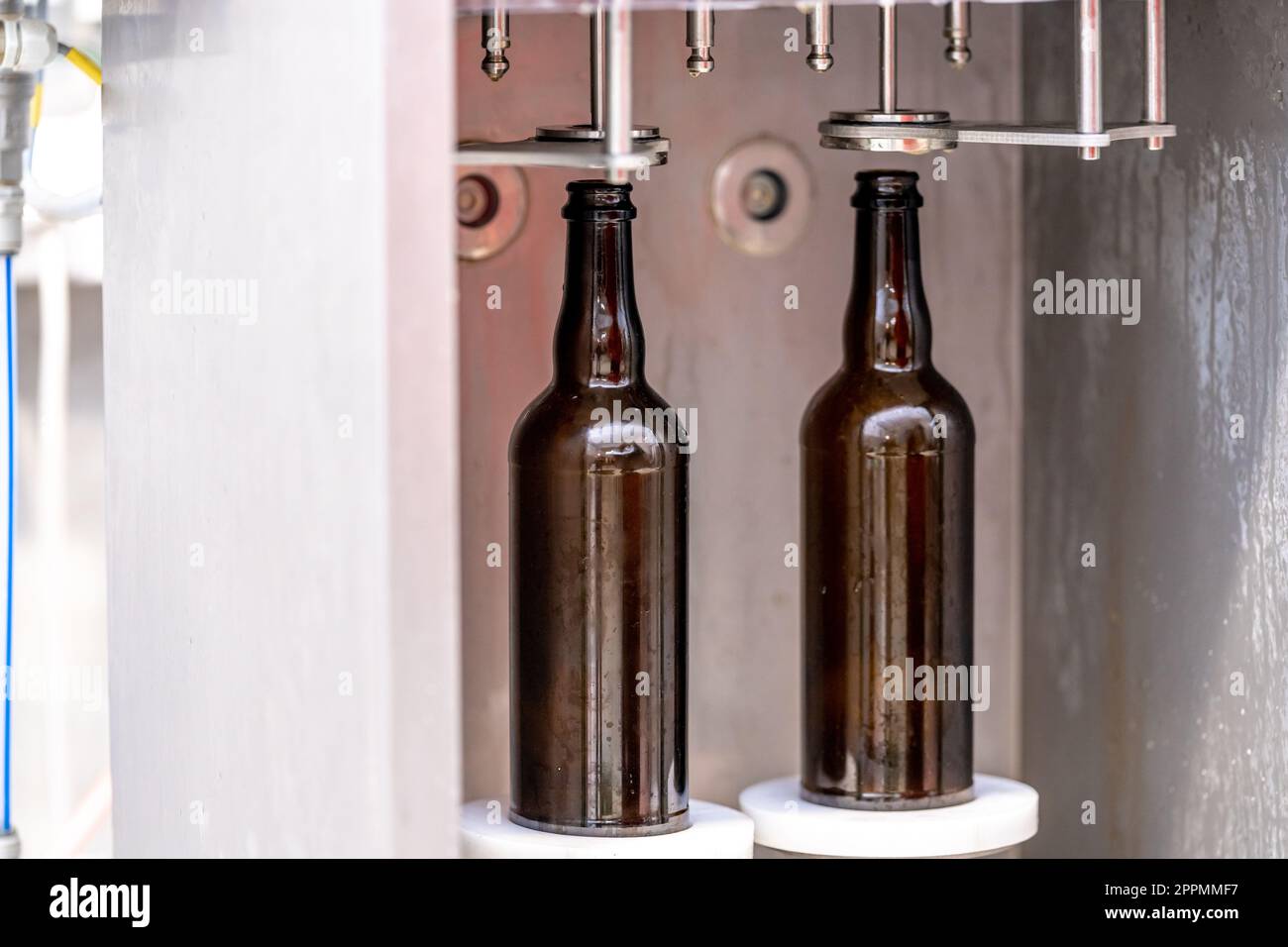 machine for washing and filling glass bottles with beer Stock Photo