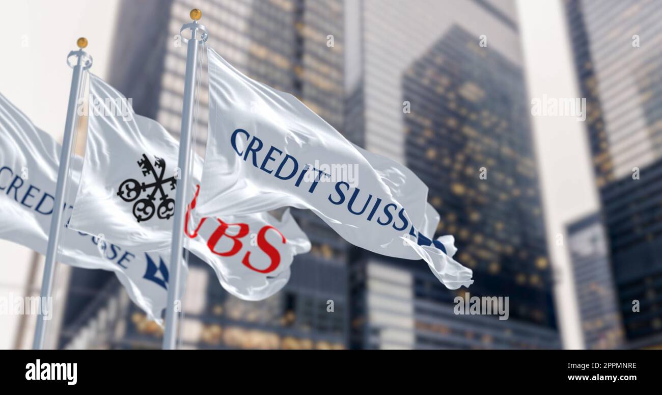 Flags of Credit Suisse and UBS fluttering in the wind in a financial district. Stock Photo