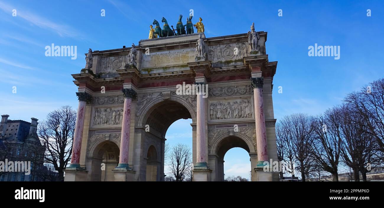 Paris, France - January 01, 2022: The people going near Arc de Triomphe du Carrousel in Paris. It was built between 1806 and 1808 to commemorate Napoleon's military victories Stock Photo