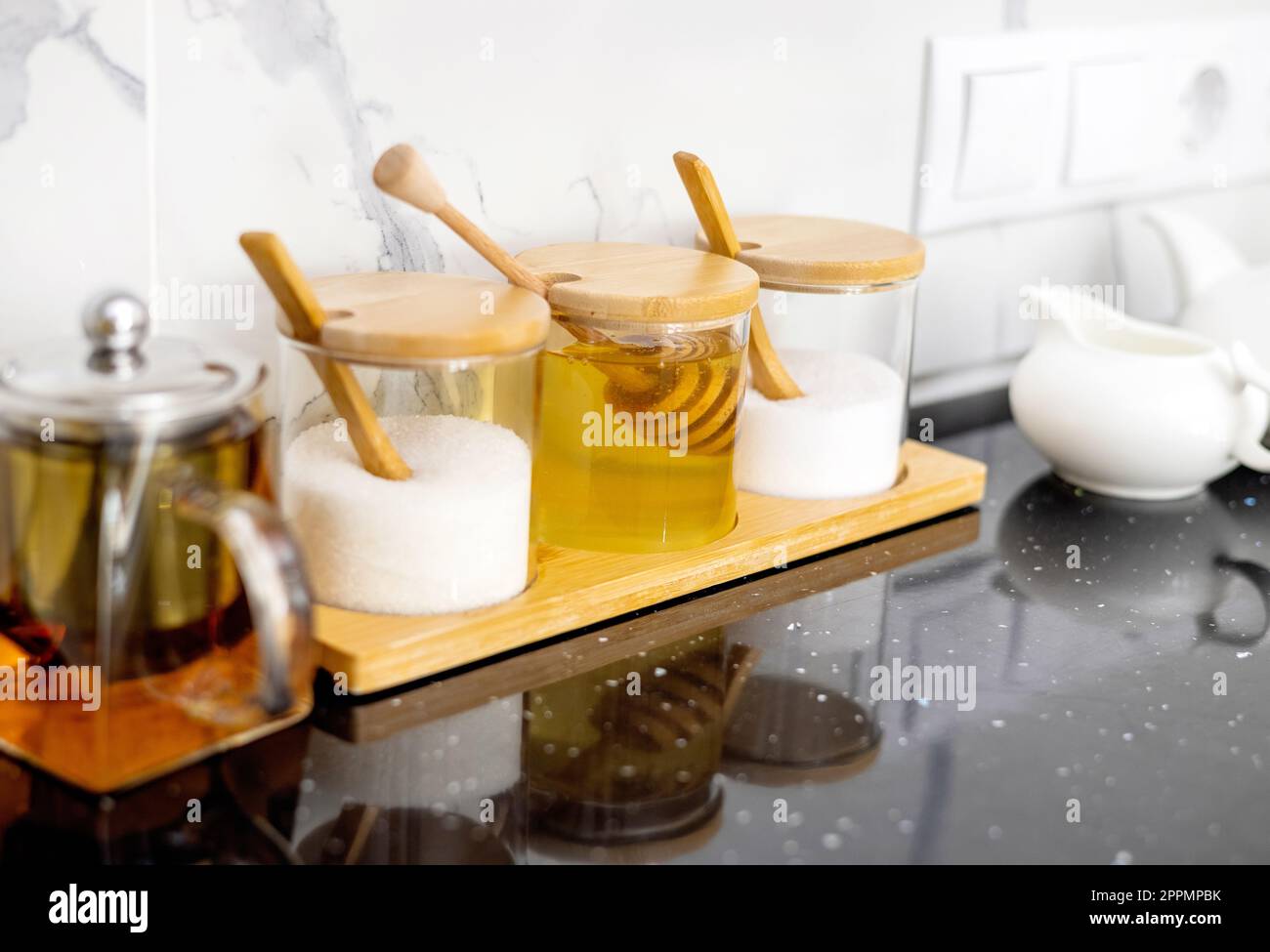 glass jars with salt sugar and honey in. modern kitchen interior Stock ...