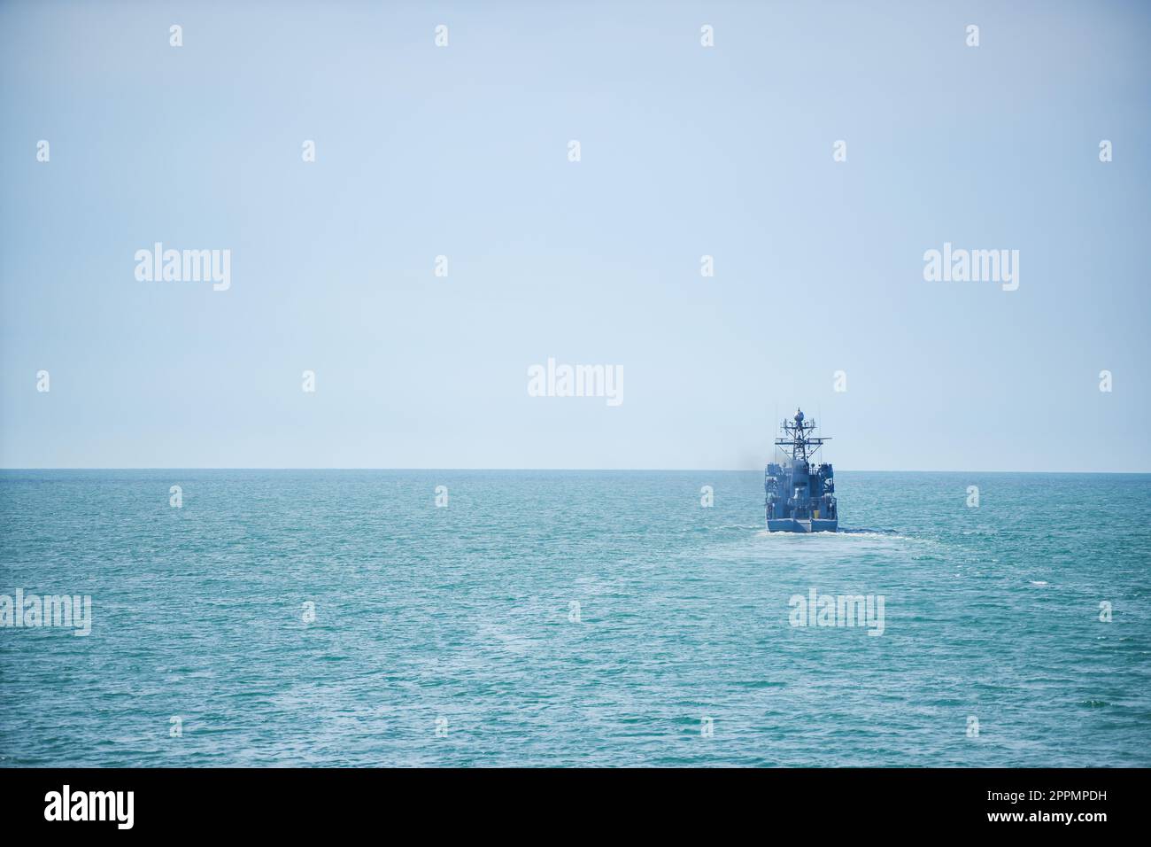 Warship sailing in still water Stock Photo