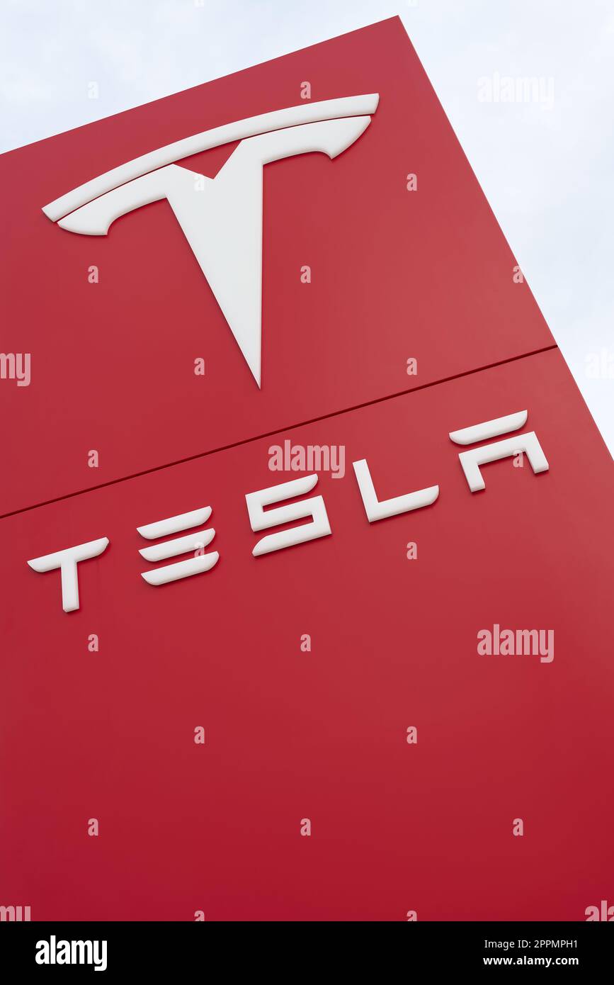 Tesla car brand advertising sign in front of a Tesla car dealership in Magdeburg in Germany Stock Photo