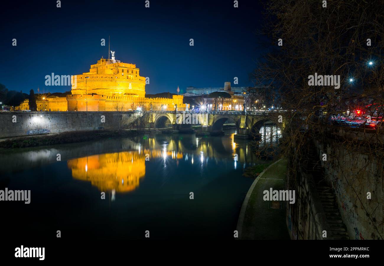 Sant' Angelo Bridge and Basilica of St. Peter at night in Rome, Italy Stock Photo