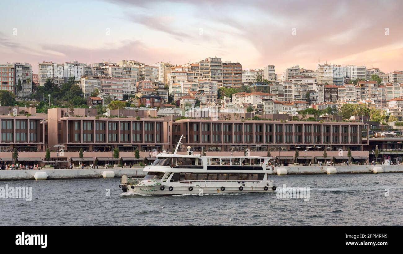 Ferry boat sailing in Bosphorus Strait in front of Galataport, Karakoy neighbourhood, Istanbul, Turkey Stock Photo