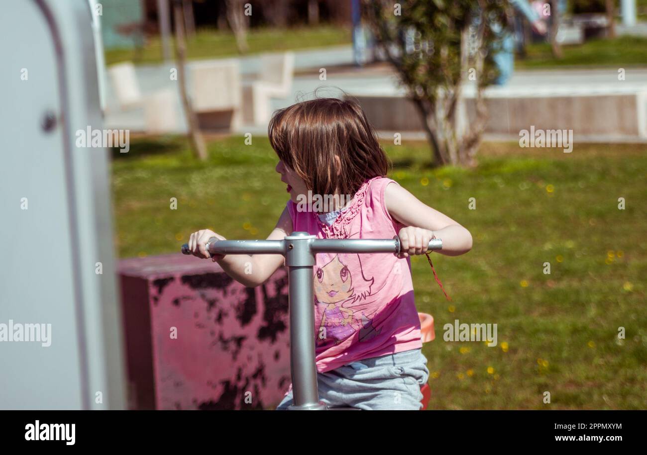 Small girl playing on the playground Stock Photo - Alamy