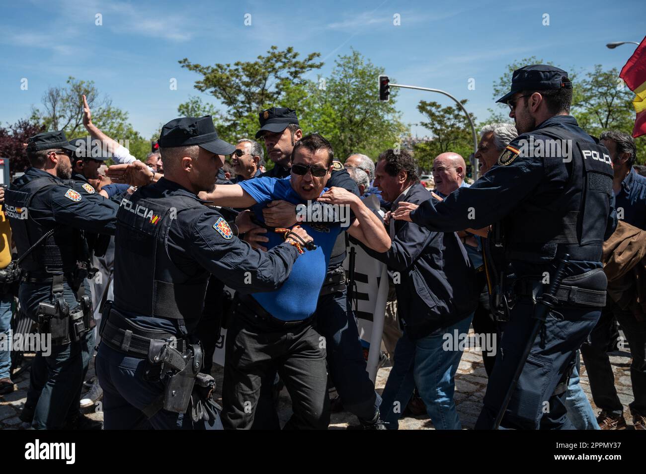 Madrid, Spain. 24th Apr, 2023. Police officers trying to block a group of members and supporters of La Falange party during a protest outside the San Isidro Cemetery the day of the exhumation of the remains of the founder of Falange, Jose Antonio Primo de Rivera. The fascist politician's remains were exhumed from the Valle de los Caidos (known now as Valle de Cuelgamuros) and transferred to the San Isidro cemetery. Credit: Marcos del Mazo/Alamy Live News Stock Photo