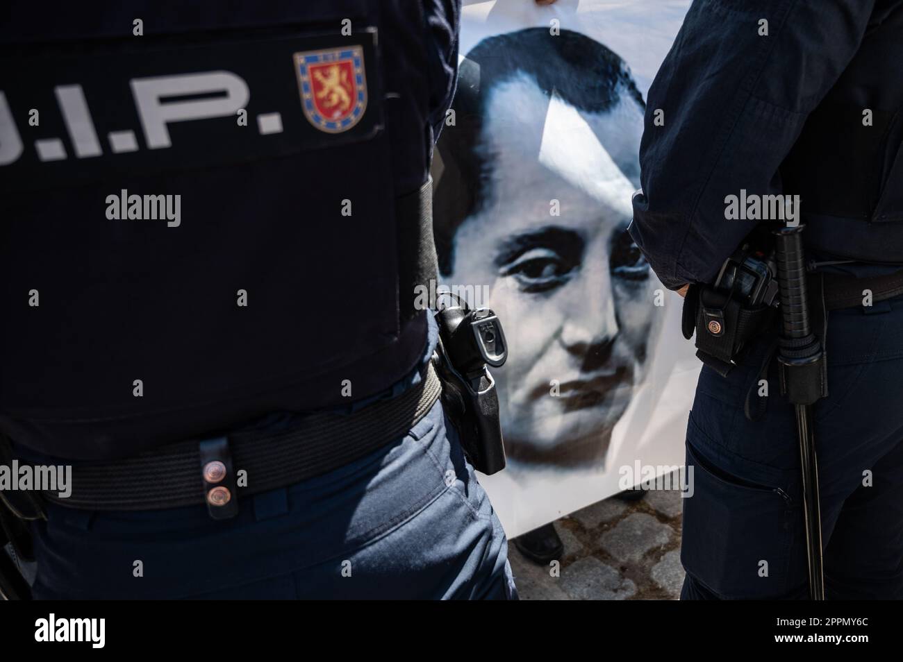 Madrid, Spain. 24th Apr, 2023. Police officers blocking a group of members and supporters of La Falange party during a protest outside the San Isidro Cemetery the day of the exhumation of the remains of the founder of Falange, Jose Antonio Primo de Rivera. The fascist politician's remains were exhumed from the Valle de los Caidos (known now as Valle de Cuelgamuros) and transferred to the San Isidro cemetery. Credit: Marcos del Mazo/Alamy Live News Stock Photo
