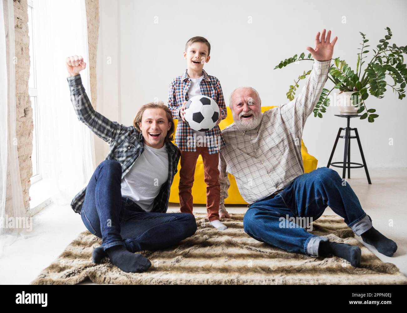 Men different generations watching football Stock Photo