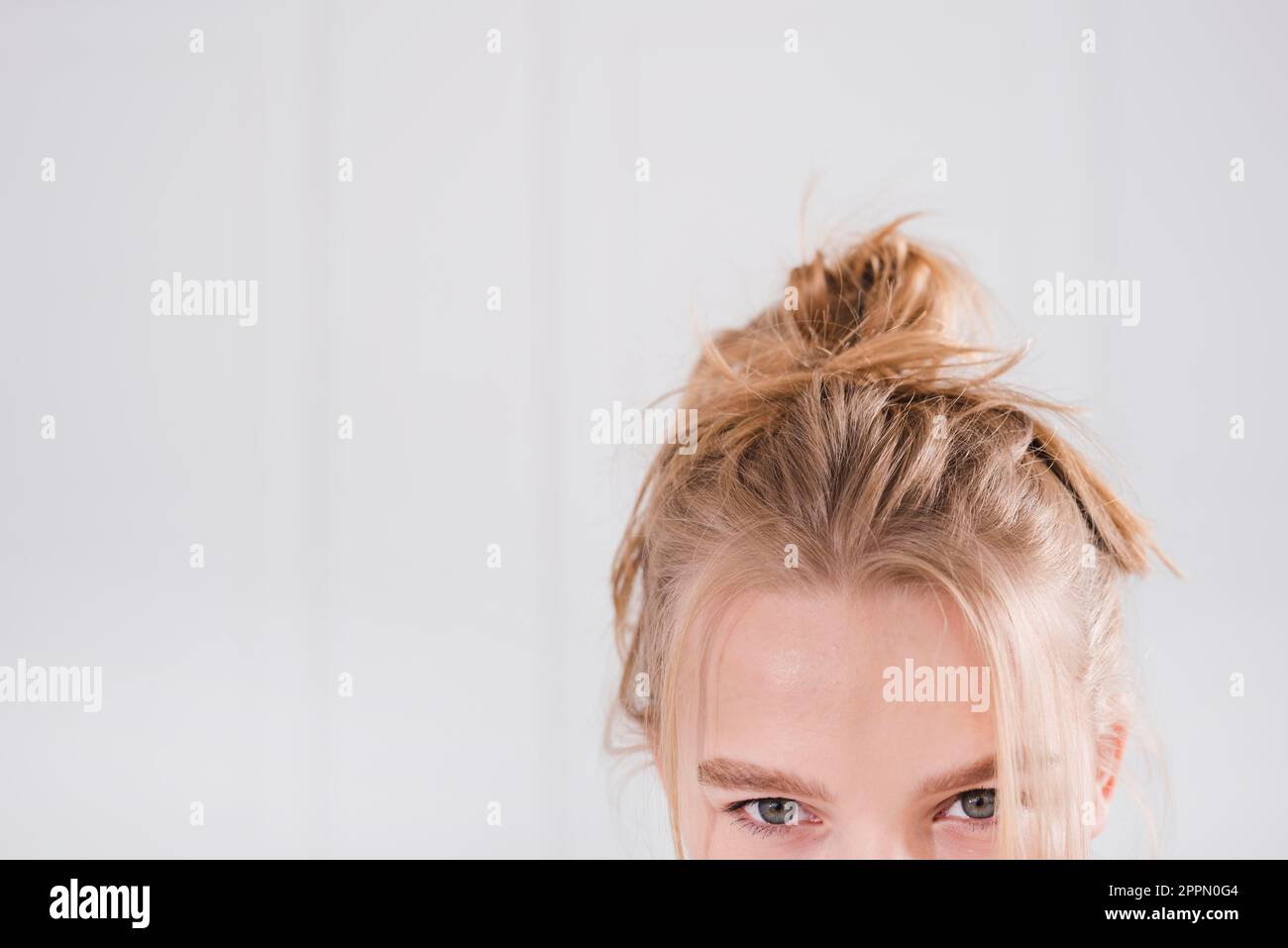 Blonde girl with messy bun Stock Photo