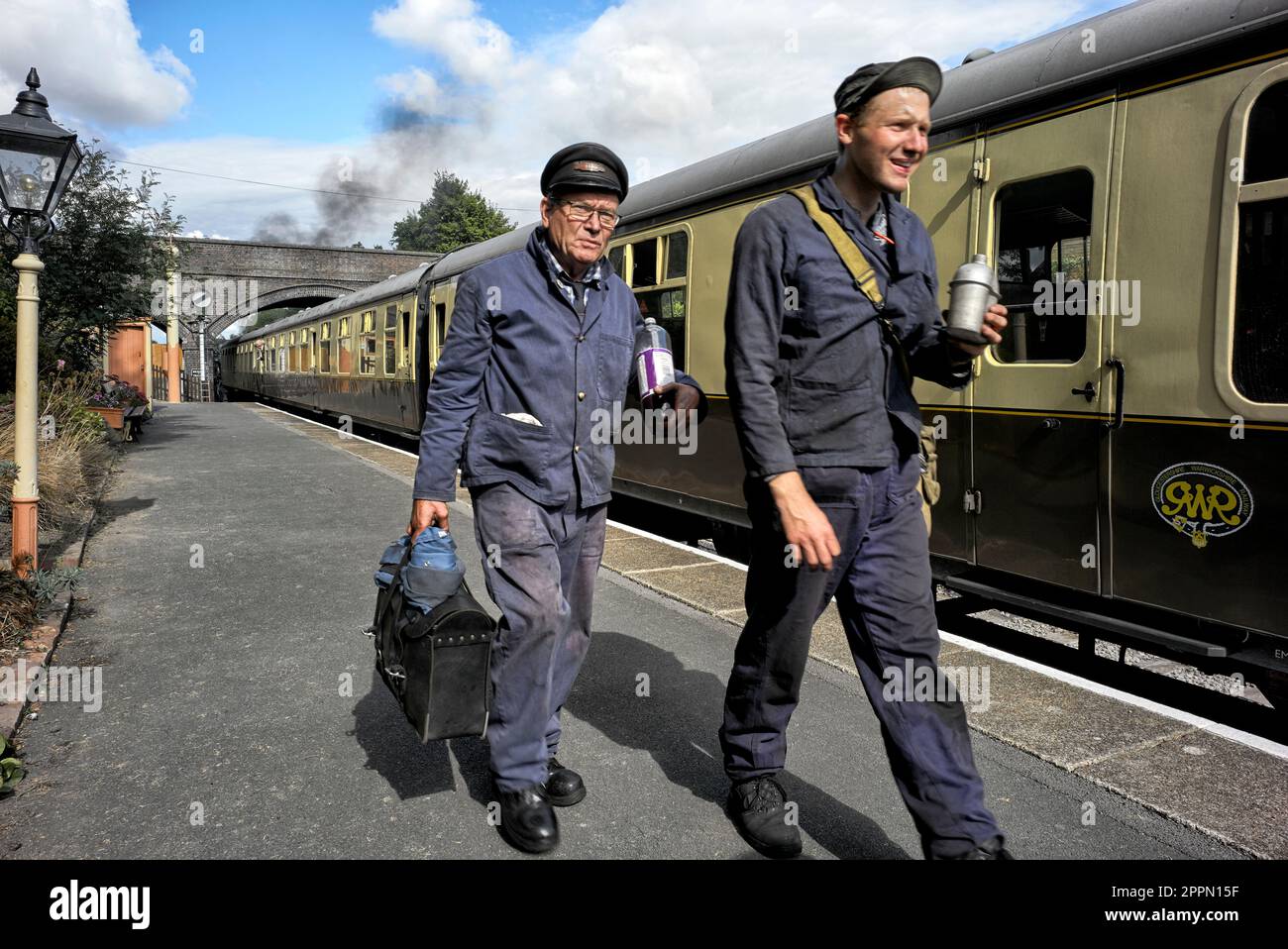 Train driver and fireman of a vintage steam train at  the GWR preserved railway station Toddington Gloucestershire England UK Stock Photo