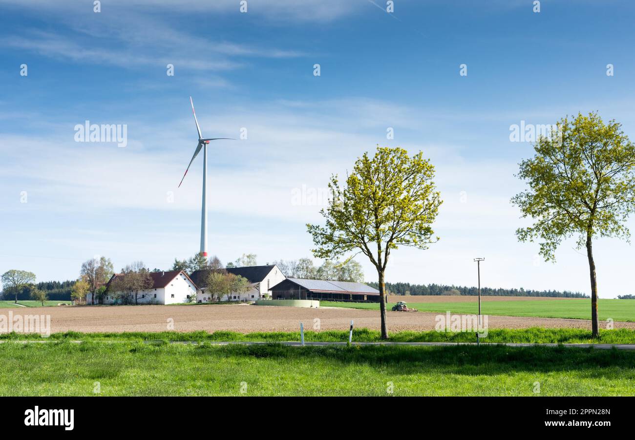 Alternative energy with a windmill at a farm Stock Photo