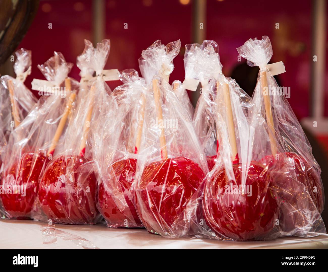 Delicious red candy apples in plastic foil Stock Photo - Alamy