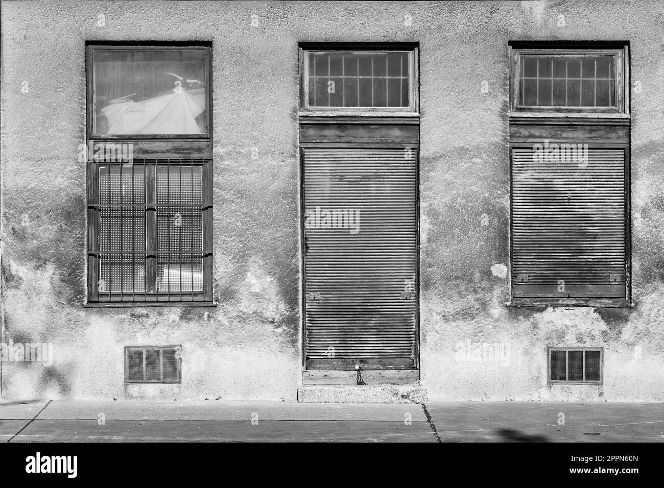closed door with closed windows at a dirty house facade in Vienna Stock Photo