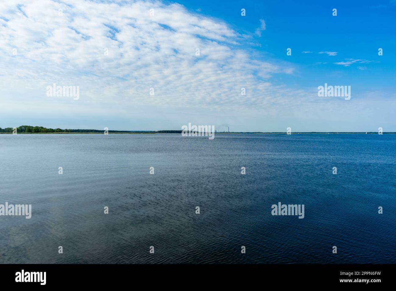 water surface, ripples on the water and clouds in the blue sky Stock ...