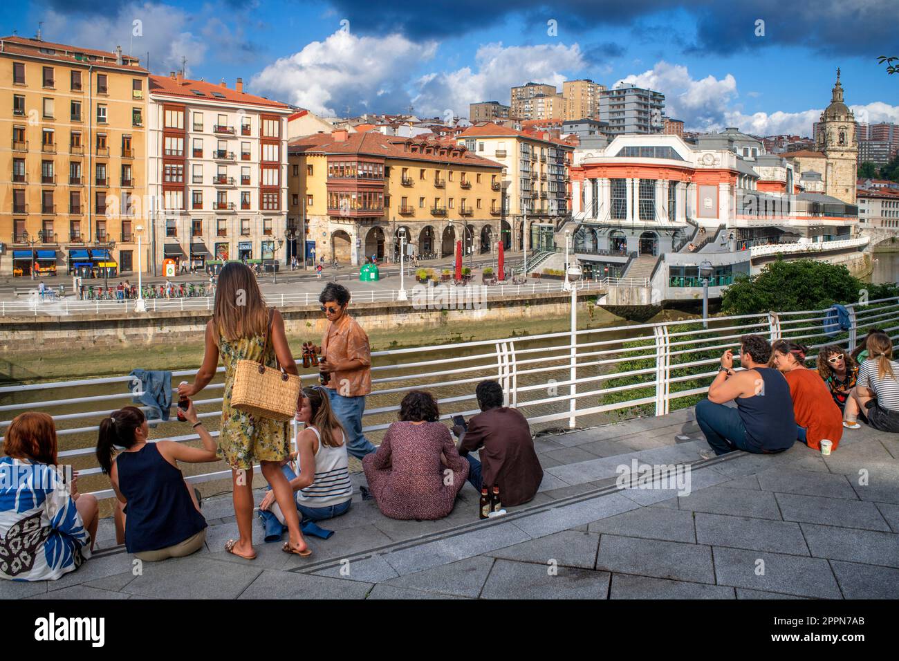 Lifestyle meeting point in front of the historic market La Ribera market along the Nervion River, Bilbao, Spain, Europe Stock Photo