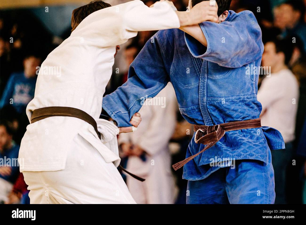 male judoists hold opponent kimono with their hands, judo fight
