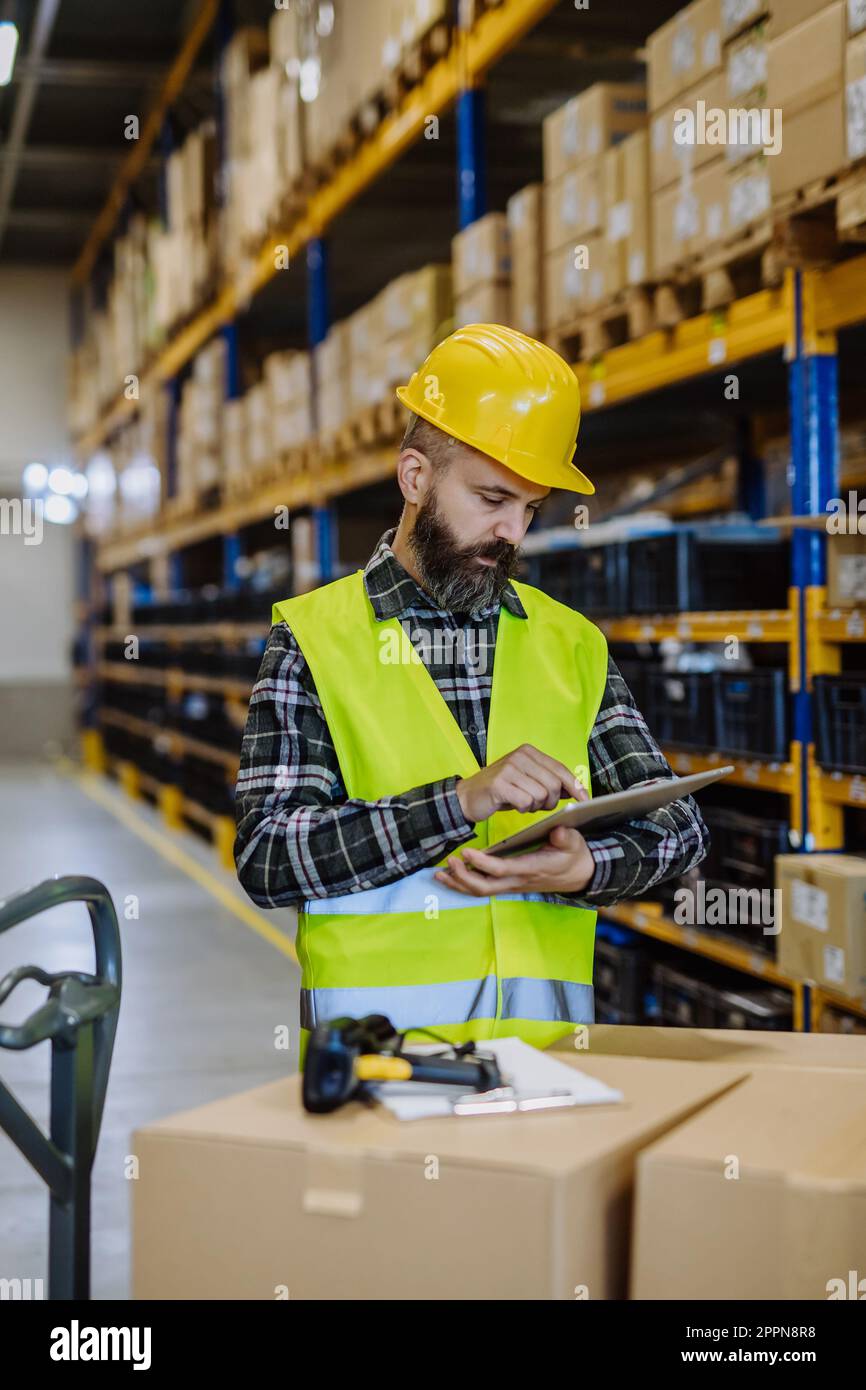 Warehouse worker stocking goods in a warehouse Stock Photo Alamy