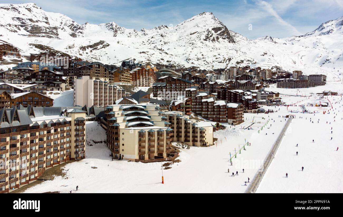 Aerial view of the snowy Val Thorens ski resort in the French Alps in winter - Luxurious hotels secluded in a white valley in altitude among high peak Stock Photo