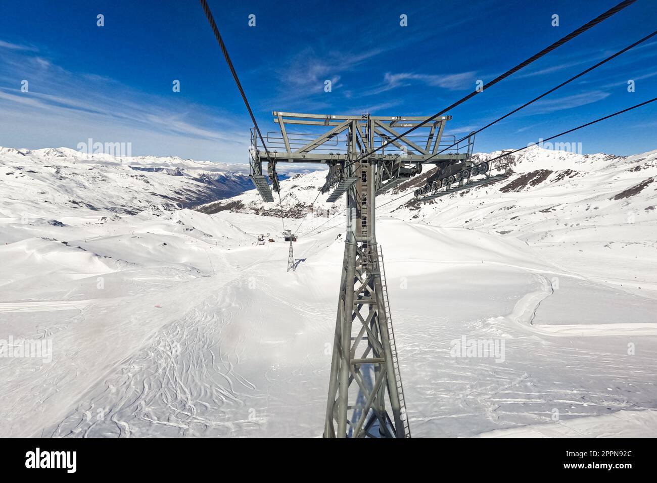 Chairlift post at the top of a snowy mountain above the Val Thorens ski resort in the French Alps Stock Photo