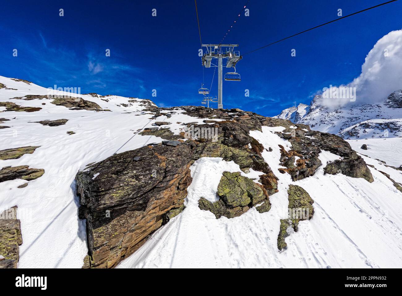 Chairlift post at the top of a snowy mountain above the Val Thorens ski resort in the French Alps Stock Photo