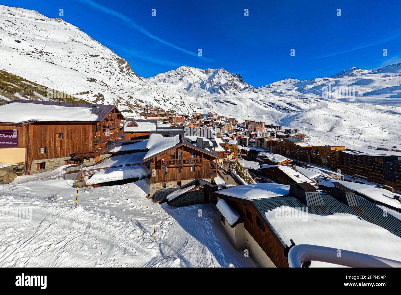 Snow-covered rooftops in the town of Val Thorens, a ski resort in the French Alps surrounded by high peaks Stock Photo