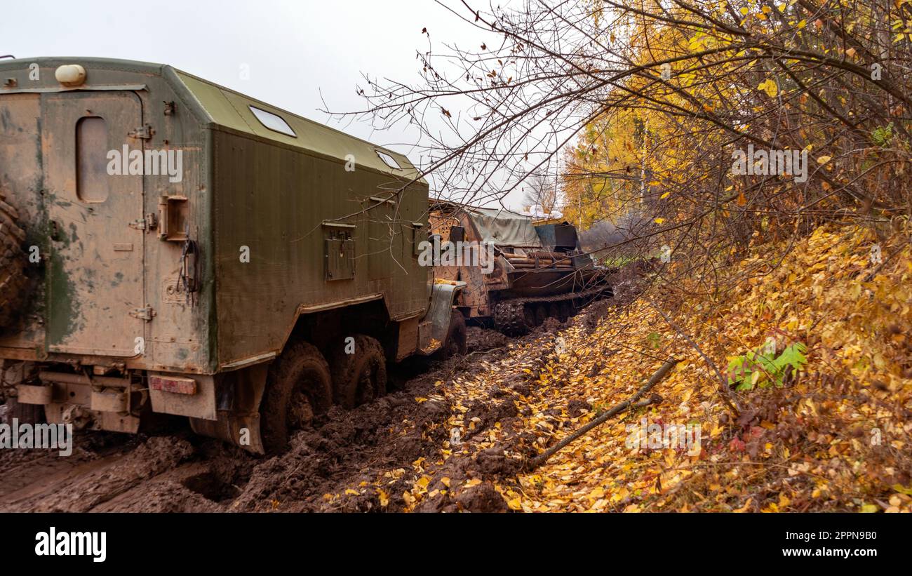 tracked vehicles pull a military truck out of the mud Stock Photo Alamy