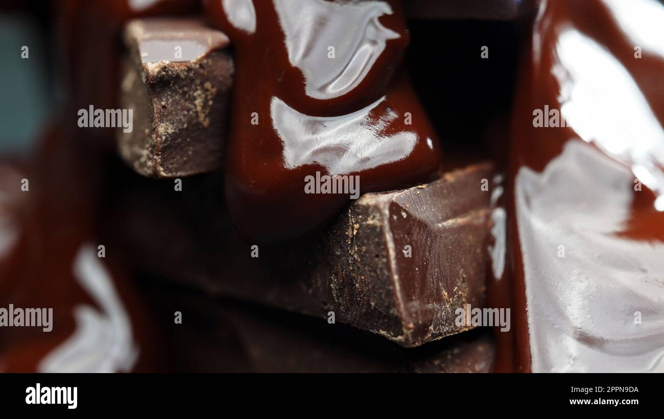 Melted chocolate flows over the chocolate bars Stock Photo Alamy