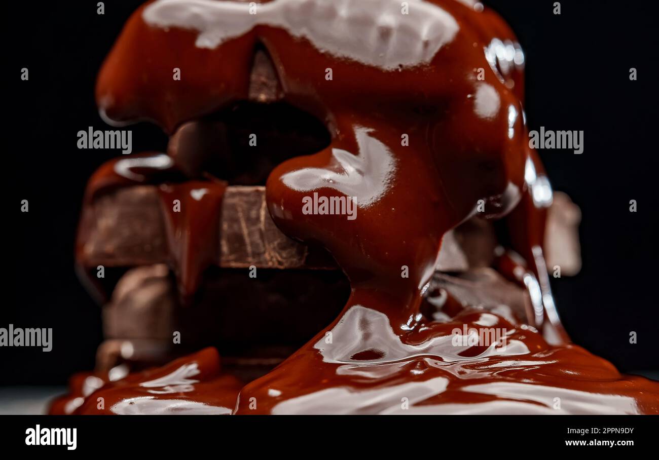 Melted chocolate flows over the chocolate bars Stock Photo Alamy