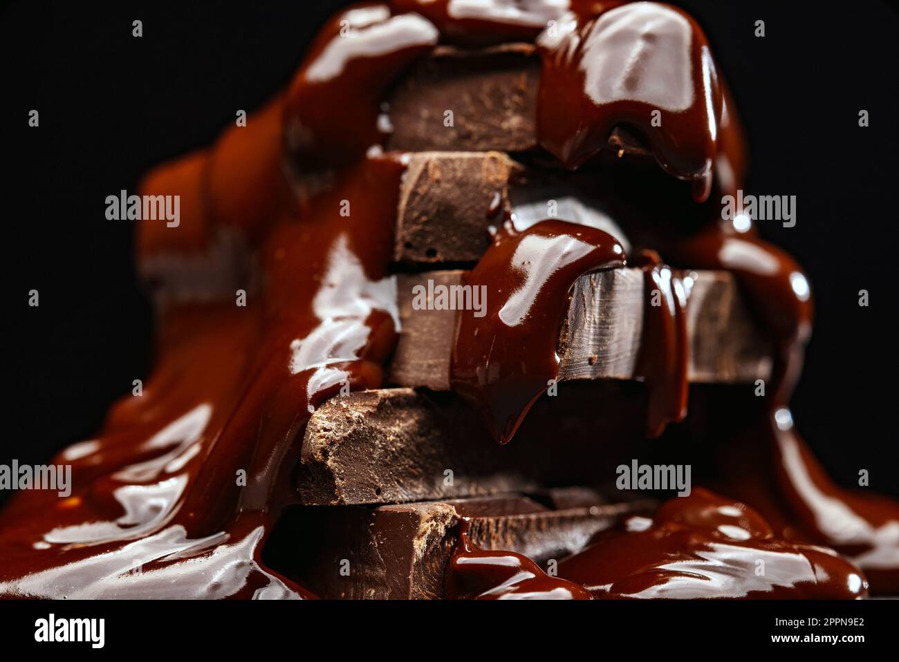 Melted chocolate flows over the chocolate bars Stock Photo Alamy