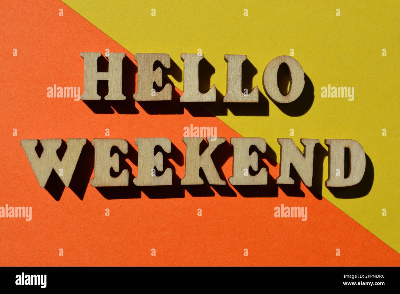 Hello Weekend, words in wooden alphabet letters isolated on bright and colourful background Stock Photo