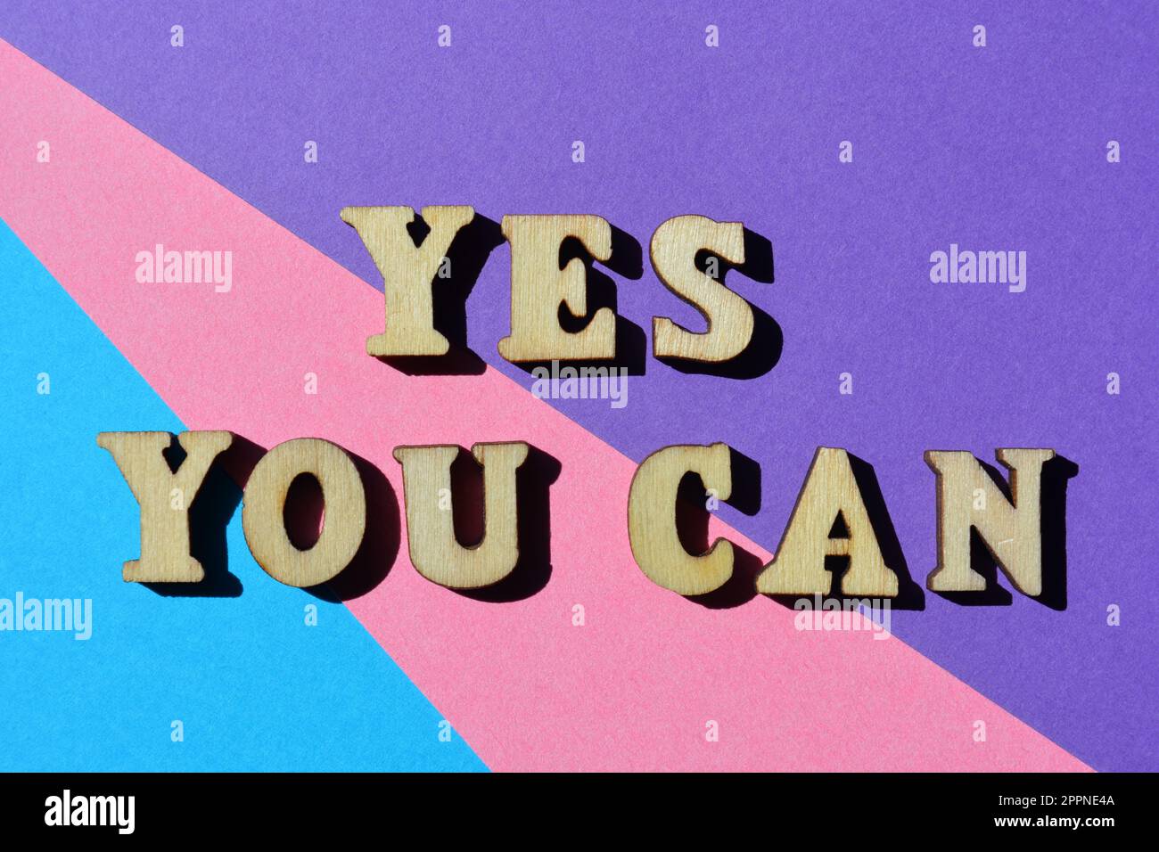 Yes You Can, words in wooden alphabet letters isolated on colourful background Stock Photo