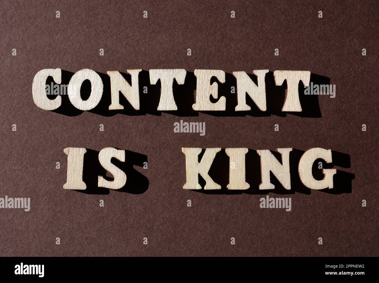 Content is King, words in wooden alphabet letters isolated on brown background Stock Photo