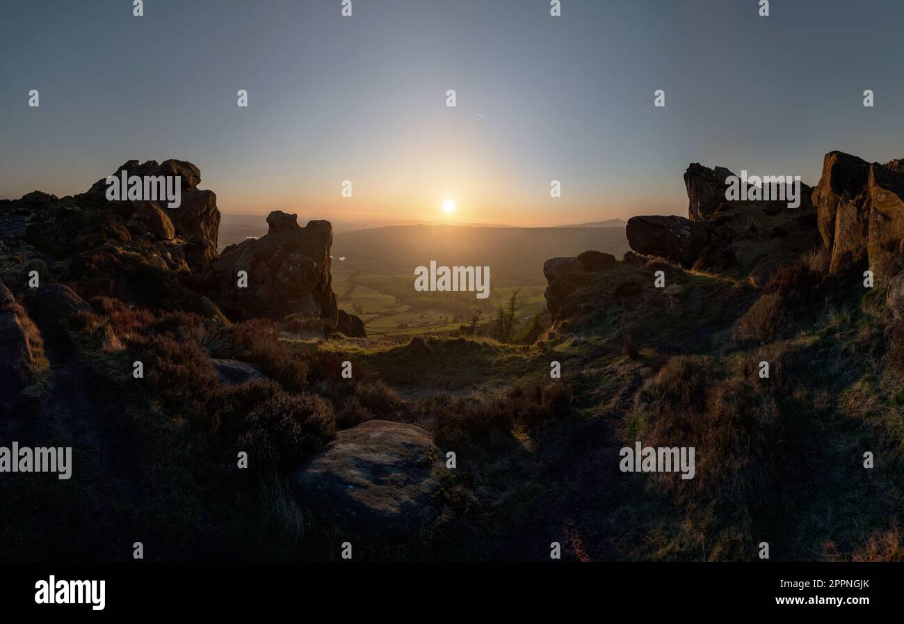 Sunset framed by the rocks of the Roaches, in the countryside of the Staffordshire part of the Peak District, the end of a day in the national park Stock Photo