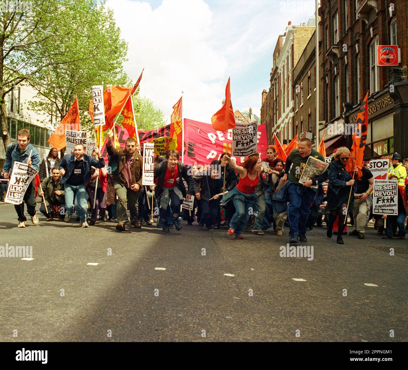 May day protest 1998, protesters and demonstrators running up Theobalds Road Holborn with anti capitalist posters and banners Stock Photo