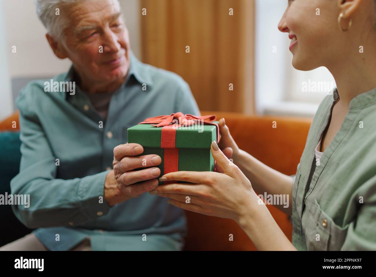 Ahuevoo Senor Gift Senior man giving gift to his granddaughter Stock Photo - Alamy