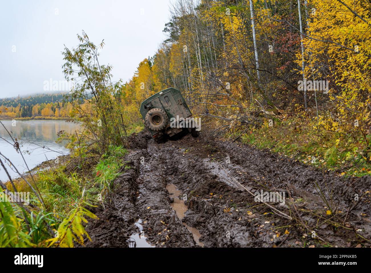 The truck got stuck on a dirty, broken forest road. Autumn thaw. Off - road. Stock Photo