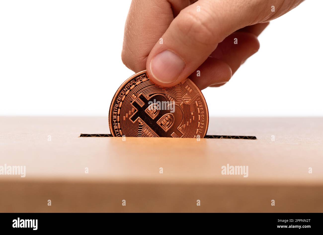 hand putting bitcoin into charity donation box Stock Photo - Alamy