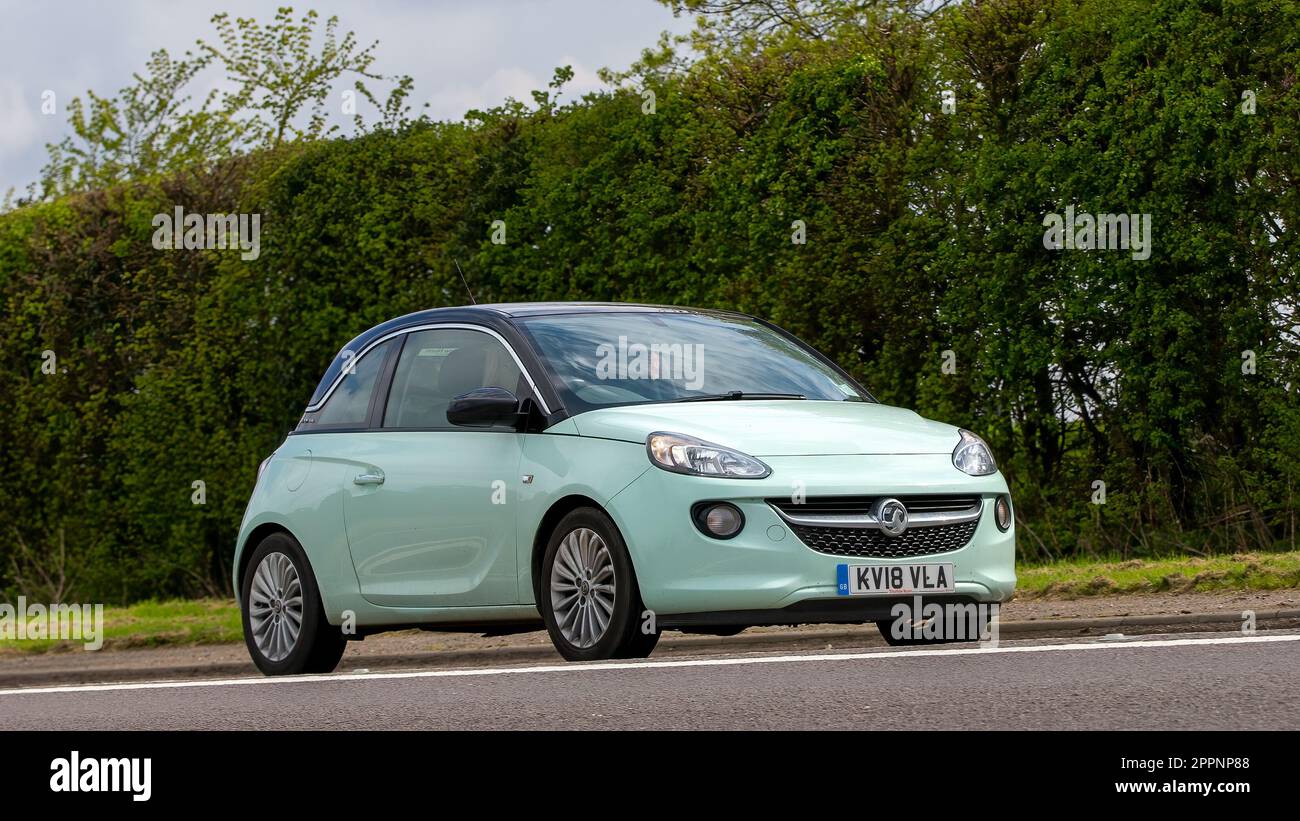 Bicester,Oxon,UK - April 23rd 2023. 2018 green Vauxhall Adam small car travelling on an English country road Stock Photo