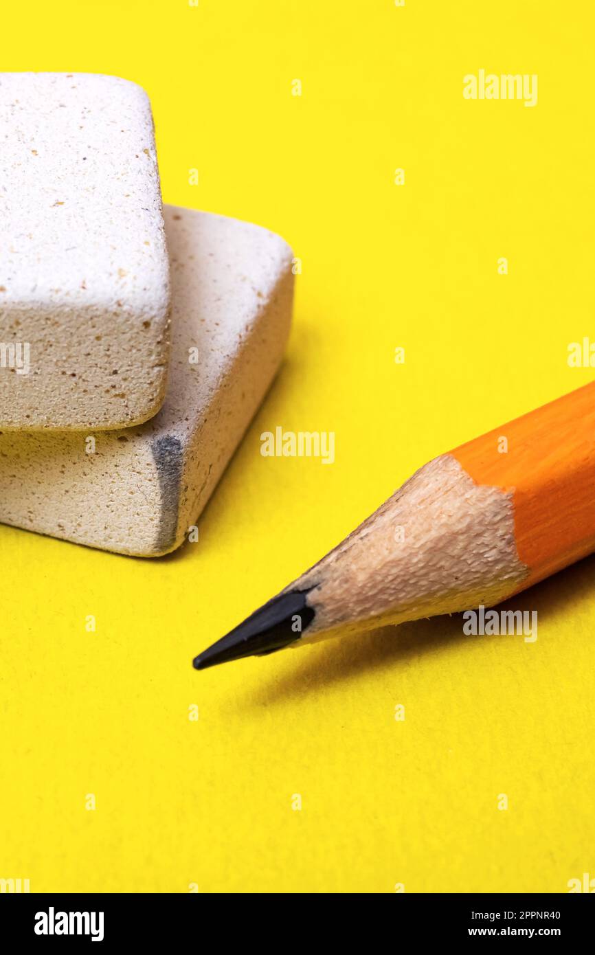 Two erasers and pencil on a yellow background Stock Photo