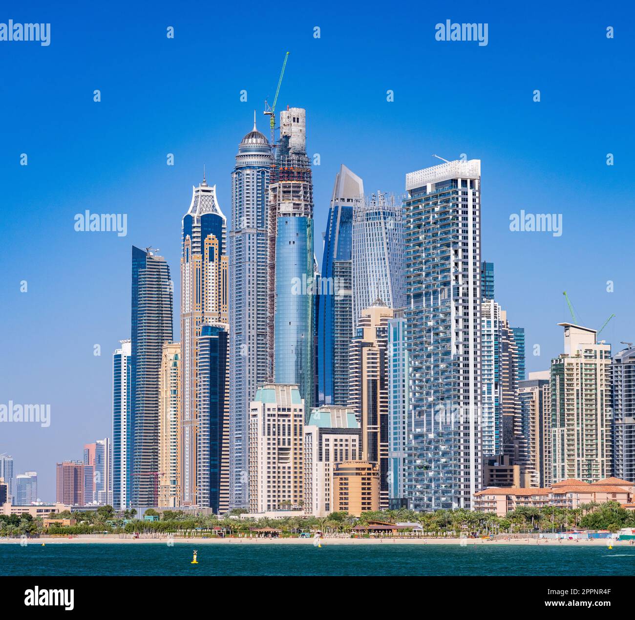 Construction of new apartments among hotels on oceanfront in Jumeirah Beach Residence area of Dubai Stock Photo