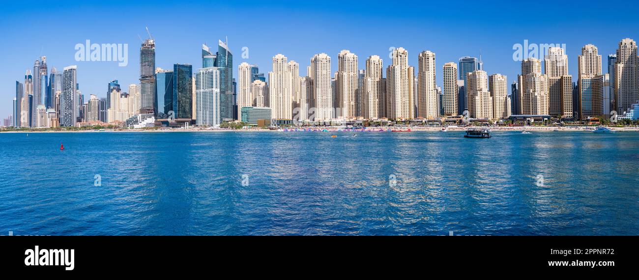 Wide panorama of new apartments among hotels on oceanfront in Jumeirah Beach Residence area of Dubai Stock Photo