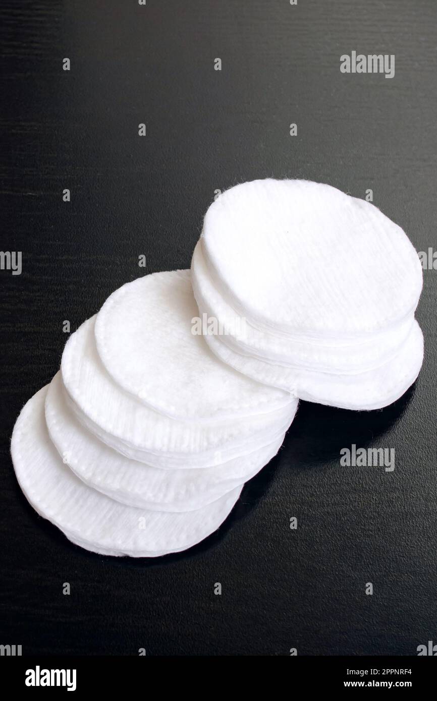 Cotton discs and buds black wooden table close up Stock Photo