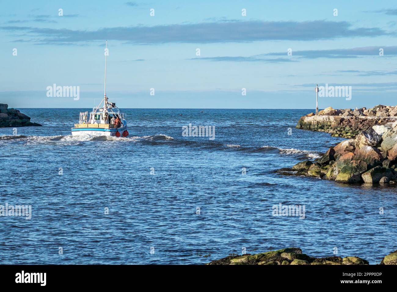 Crab fishermen exiting the safety of Glace Bay Harbour Nova Scotia after dropping their catch