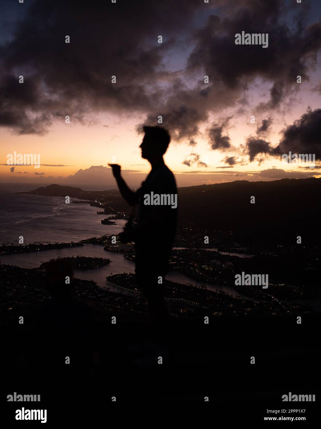 Man Watching Sunset from top of Koko Head Crater. High quality photo. A