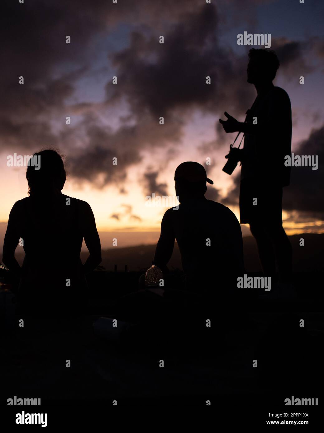 Man Watching Sunset from top of Koko Head Crater. High quality photo. A