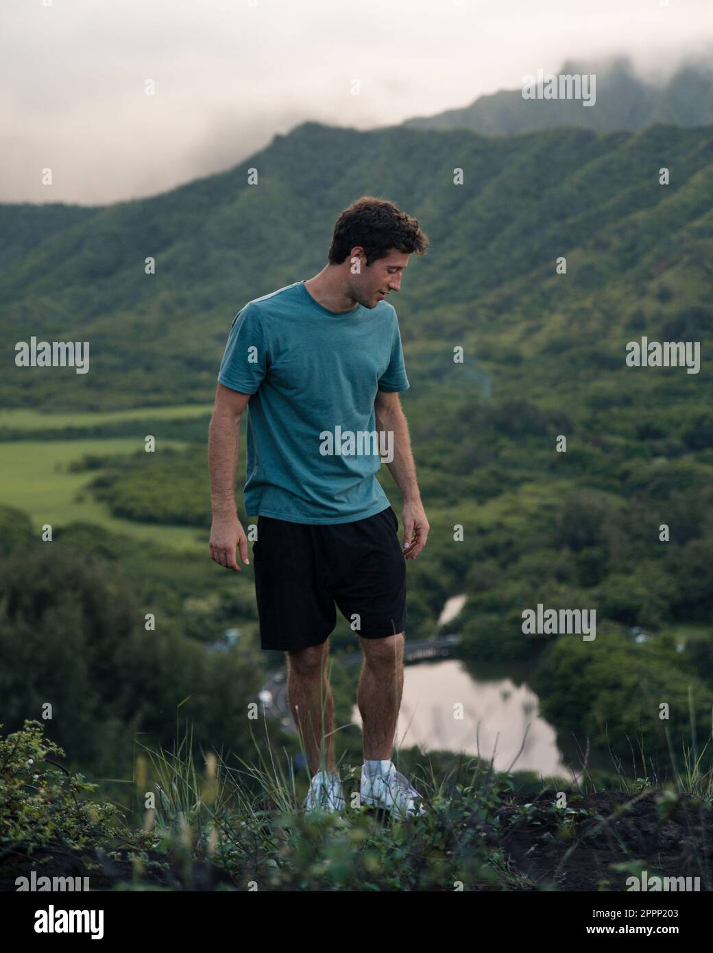 Man Looking out at Crouching Lion Hike on Oahu, Hawaii. High quality photo. Beautiful view of Oahu's east coast. Stock Photo